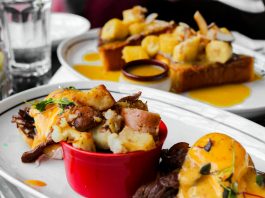 Close-up of delicious eggs benedict and banana topping toast served in Montreal cafe.