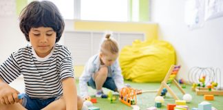 Kids enjoying playtime with toys and blocks in a bright kindergarten classroom.