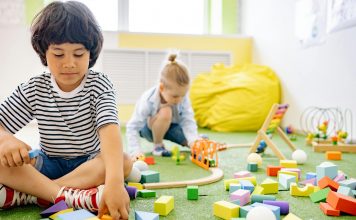 Best Daycares in North Bergen for Working Parents (2026 Guide) Kids enjoying playtime with toys and blocks in a bright kindergarten classroom.