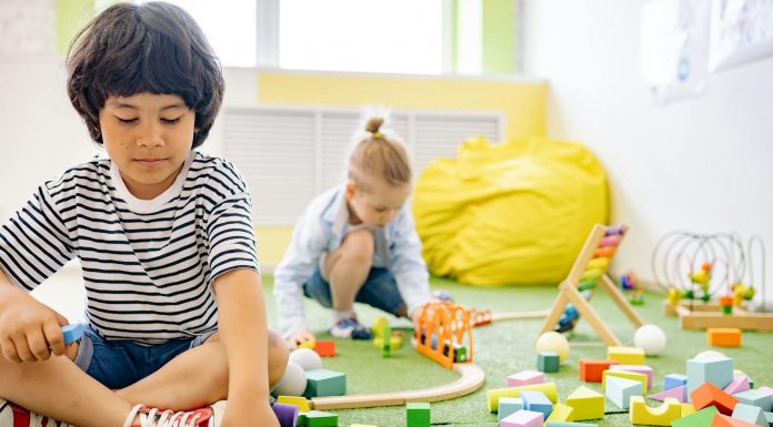 Best Daycares in North Bergen for Working Parents (2026 Guide) Kids enjoying playtime with toys and blocks in a bright kindergarten classroom.
