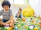 Kids enjoying playtime with toys and blocks in a bright kindergarten classroom.