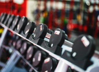 Best Gyms in Hoboken for Every Budget (2026 Guide) Close-up view of dumbbells in a modern gym setting, emphasizing fitness and training.