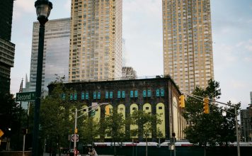 Best Neighborhoods to Live in Union City in 2026: A Local’s Guide to Hudson County Living A vibrant intersection in Jersey City with towering skyscrapers and a historic building.