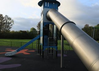 Best Parks in Newark for Families: Top Green Spaces in 2026 A modern outdoor playground slide set in a green park in England.