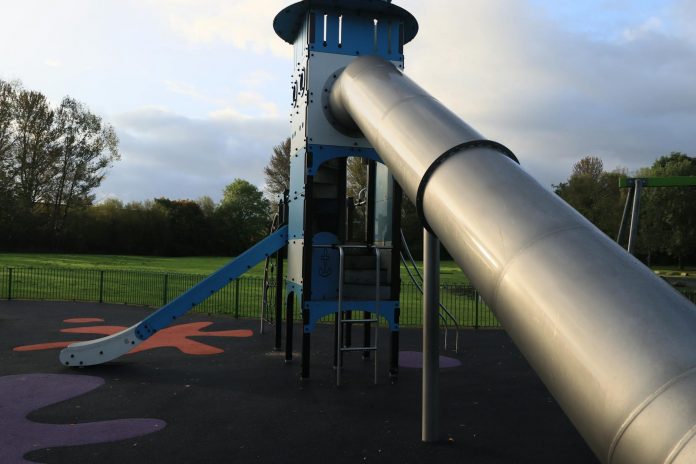 best-parks-newark-families A modern outdoor playground slide set in a green park in England.