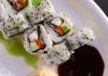 Appetizing sushi rolls with avocado, seaweed, and sesame seeds.