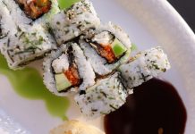 Appetizing sushi rolls with avocado, seaweed, and sesame seeds.