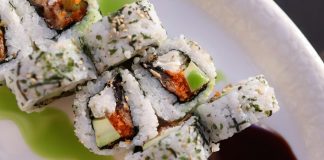 Appetizing sushi rolls with avocado, seaweed, and sesame seeds.