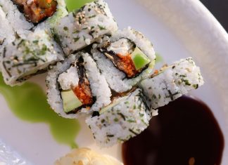 Appetizing sushi rolls with avocado, seaweed, and sesame seeds.