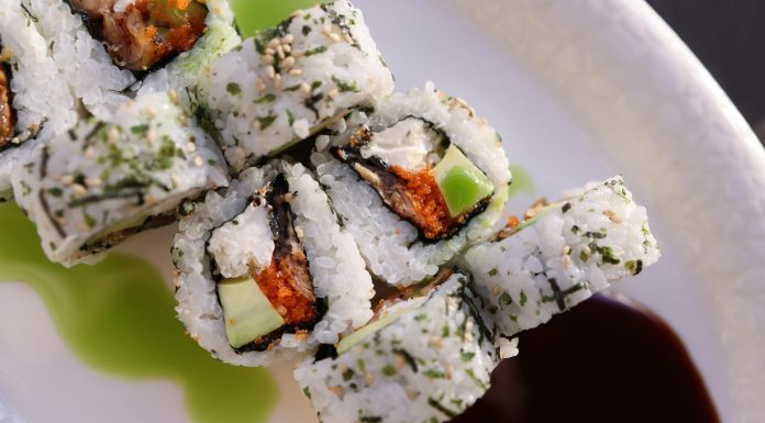 Appetizing sushi rolls with avocado, seaweed, and sesame seeds.