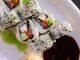 Appetizing sushi rolls with avocado, seaweed, and sesame seeds.