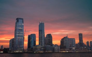 Best Things To Do in Newark at Night in 2026: A Local Guide Stunning view of New York City skyline with a vibrant sunset reflecting on skyscrapers.