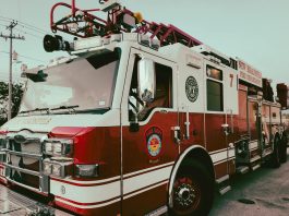Red and white fire truck from New Braunfels Fire Department parked outdoors.