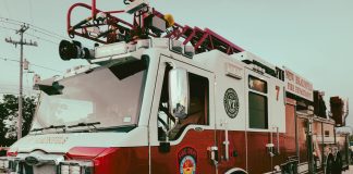 Red and white fire truck from New Braunfels Fire Department parked outdoors.