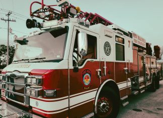 Red and white fire truck from New Braunfels Fire Department parked outdoors.
