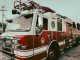 Red and white fire truck from New Braunfels Fire Department parked outdoors.