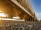 Low-angle view of a freight train with sunlight shining through, captured in Reads Landing, MN.