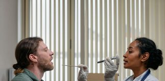 A doctor examining a patient's throat in a clinical setting, highlighting professional healthcare.