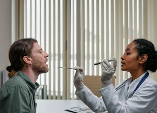 A doctor examining a patient's throat in a clinical setting, highlighting professional healthcare.