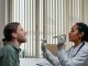 A doctor examining a patient's throat in a clinical setting, highlighting professional healthcare.