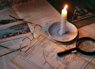 BREAKING: Thomas Stechschulte Obituary Published in West New York Cozy vintage scene with candle, map, glasses, and magnifying glass.