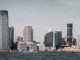 A breathtaking view of Jersey City's skyline from across the Hudson River with modern skyscrapers and waterfront buildings.