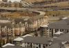 Aerial view of urban residential apartments featuring an American flag, depicting city life.