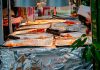 Explore a diverse range of delicious Asian street food at a bustling outdoor market stall.