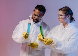 Ebola outbreak in Africa: What Hudson County needs to know Two scientists in protective gear analyze chemical samples in a laboratory setting.
