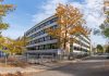 A school building in Québec city surrounded by colorful autumn trees.