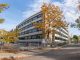 A school building in Québec city surrounded by colorful autumn trees.