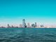 Lo Que Los Locales Aman de Vivir en Jersey City en 2026 Panoramic view of Manhattan skyline with modern skyscrapers under a clear blue sky.