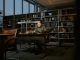 NJCU Faculty Union Gives $200K More to Support Research and Teaching A man intensely studies in a quiet library, surrounded by books and soft lighting.