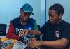 Two students assembling a robot in a hands-on STEM workshop in Accra, Ghana.
