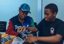 Two students assembling a robot in a hands-on STEM workshop in Accra, Ghana.