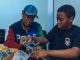 Two students assembling a robot in a hands-on STEM workshop in Accra, Ghana.
