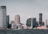 A breathtaking view of Jersey City's skyline from across the Hudson River with modern skyscrapers and waterfront buildings.