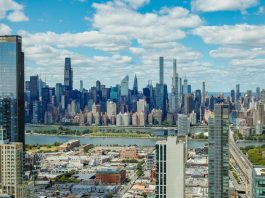Explore the stunning New York City skyline with a clear view of iconic skyscrapers under a vibrant sky.