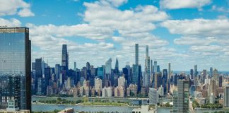 Explore the stunning New York City skyline with a clear view of iconic skyscrapers under a vibrant sky.