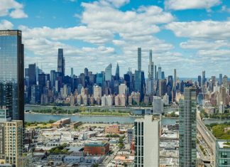 Explore the stunning New York City skyline with a clear view of iconic skyscrapers under a vibrant sky.