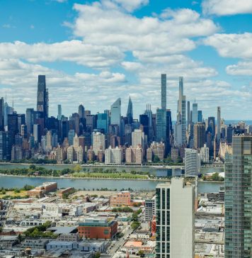 Explore the stunning New York City skyline with a clear view of iconic skyscrapers under a vibrant sky.
