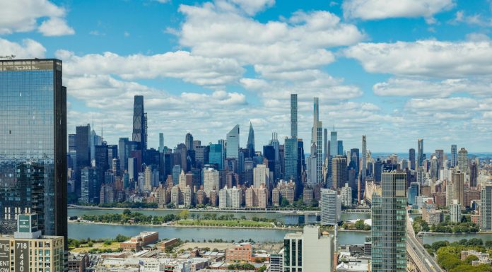 Explore the stunning New York City skyline with a clear view of iconic skyscrapers under a vibrant sky.
