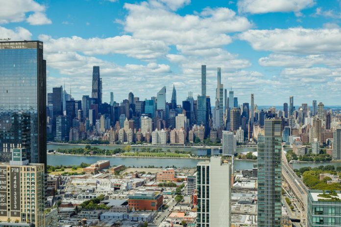 Explore the stunning New York City skyline with a clear view of iconic skyscrapers under a vibrant sky.