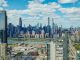 Explore the stunning New York City skyline with a clear view of iconic skyscrapers under a vibrant sky.