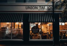 Street view of Union Taproom with warm night lighting and visible patrons inside.
