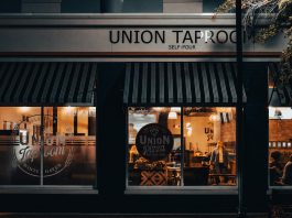 Street view of Union Taproom with warm night lighting and visible patrons inside.