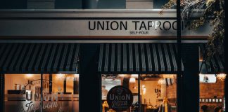 Street view of Union Taproom with warm night lighting and visible patrons inside.