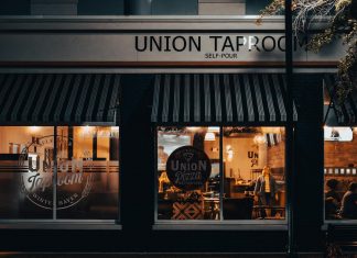 Street view of Union Taproom with warm night lighting and visible patrons inside.