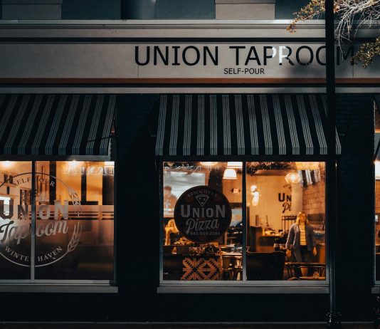 Street view of Union Taproom with warm night lighting and visible patrons inside.
