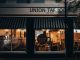 Street view of Union Taproom with warm night lighting and visible patrons inside.